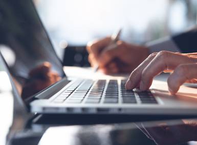 man typing on a computer