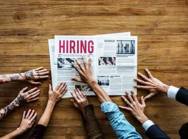 Hands grabbing for a hiring paper