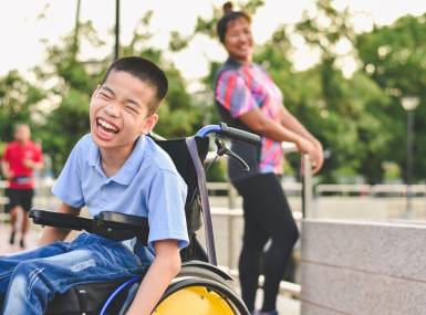 Disabled child on wheelchair is play and learn in the outdoor park like other people, Life in the education age of special children, Happy disability kid concept.