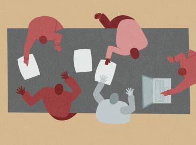 A group of people working around a table.