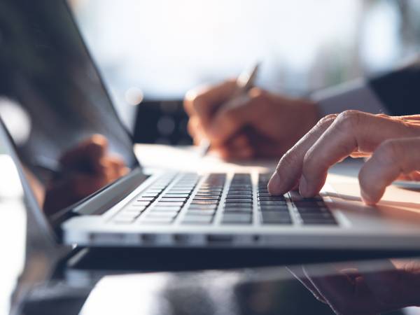 man typing on a computer