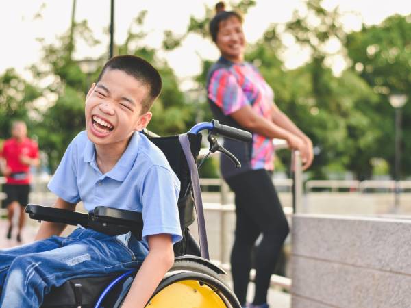 Disabled child on wheelchair is play and learn in the outdoor park like other people, Life in the education age of special children, Happy disability kid concept.
