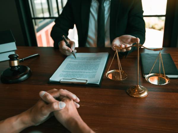 Lawyer is providing information about the client's trial at the lawyer office.