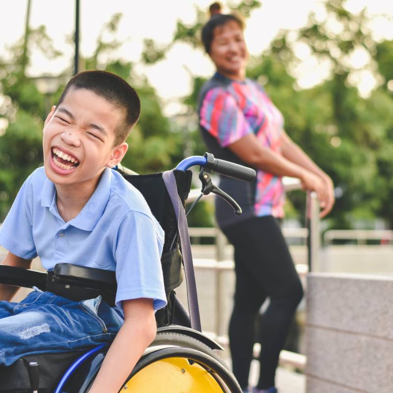 Disabled child on wheelchair is play and learn in the outdoor park like other people, Life in the education age of special children, Happy disability kid concept.