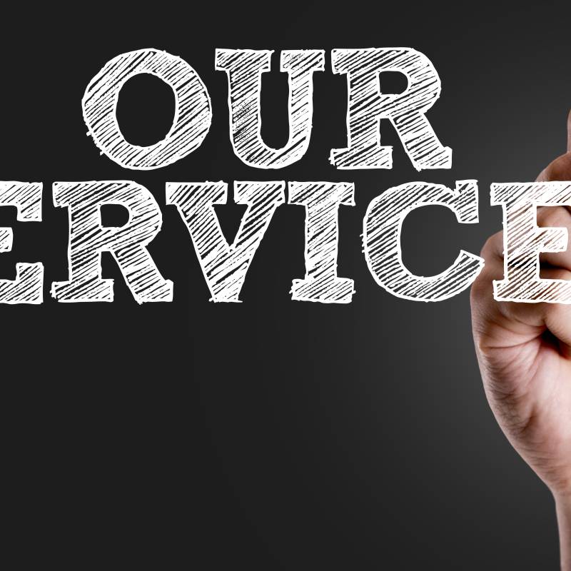 Hand writing our services with chalk