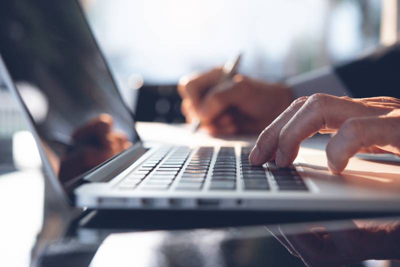 man typing on a computer