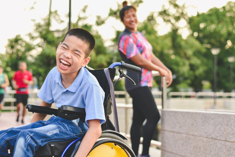 Disabled child on wheelchair is play and learn in the outdoor park like other people, Life in the education age of special children, Happy disability kid concept.